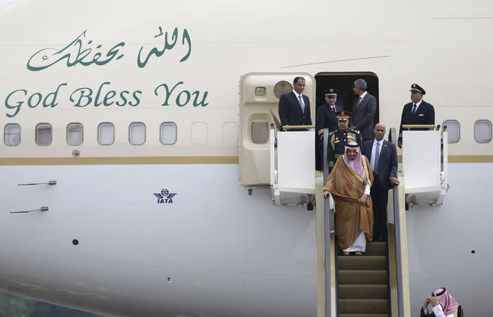 The king made quite an entrance from his gold plane (Credit: AP/REX/Shutterstock) 