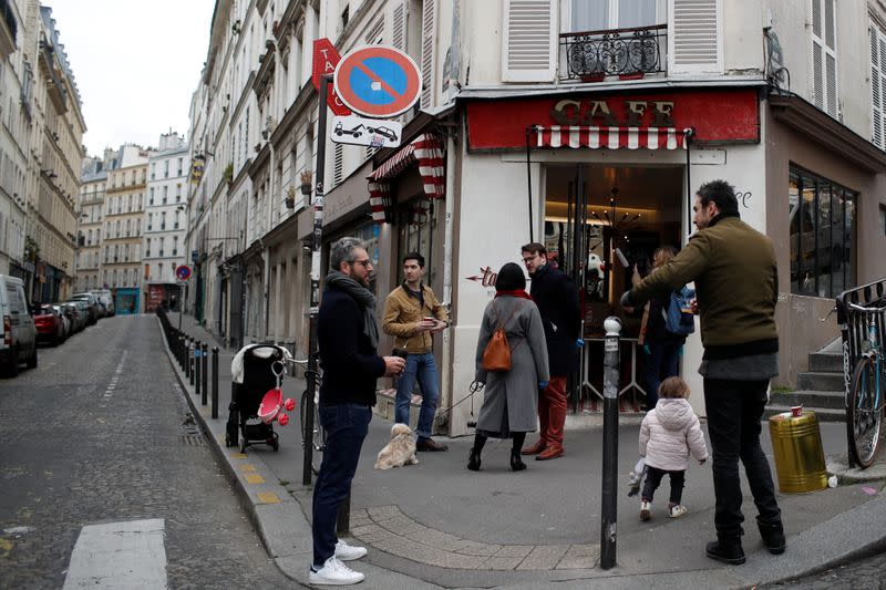 Customers queue outside the Cafe Tabac shop in Paris