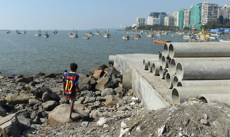 A child from the Koli community walks on the shore in Mumbai