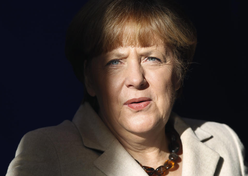 German Chancellor Angela Merkel arrives for a press conference after a cabinet meeting as part of a two day closed meeting of the German government at the Meseberg palace near Berlin, Germany, Thursday, Jan. 23, 2014. (AP Photo/Michael Sohn)
