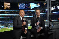 NBC Sports play-by-play announcer Mike Tirico, left, sits next to color commentator Cris Collinsworth before an NFL football game between the Los Angeles Chargers and the Miami Dolphins on Dec. 11, 2022, in Inglewood, Calif. (AP Photo/Jae C. Hong)