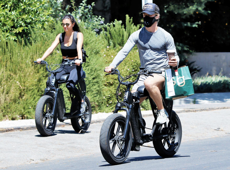 <p>Derek Hough and girlfriend Hayley Erbert bike to pick up some Sweetgreen takeout on Thursday in L.A. </p>