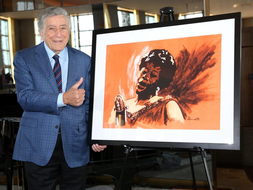 Tony Bennett poses with a painting he did of Ella Fitzgerald