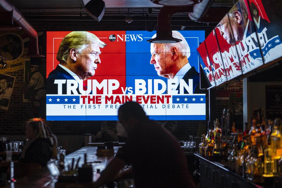 Television screens airing the first presidential debate are seen at Walters Sports Bar in Washinton.