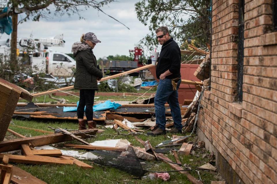 Cathy Haley and Brad Levy look over damage to the lodge at the Barn on the Brazos wedding venue Tuesday, May 4, 2021, in Blum.