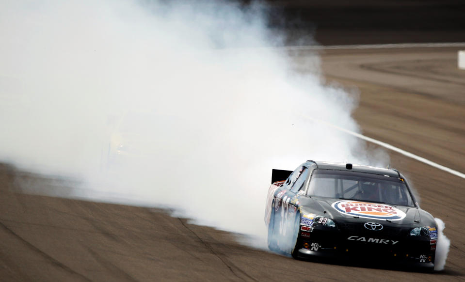 LAS VEGAS, NV - MARCH 11: Smoke flies from the #93 Burger King Toyota, driven by Travis Kvapil, after an incident in the NASCAR Sprint Cup Series Kobalt Tools 400 at Las Vegas Motor Speedway on March 11, 2012 in Las Vegas, Nevada. (Photo by Todd Warshaw/Getty Images for NASCAR)