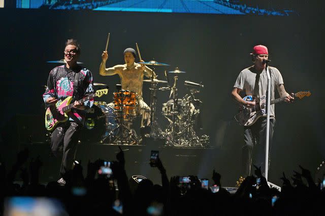 <p>Larry Marano/Shutterstock</p> Mark Hoppus, Travis Barker and Tom DeLonge of Blink-182 perform at The FLA Live Arena in Florida July 11, 2023.