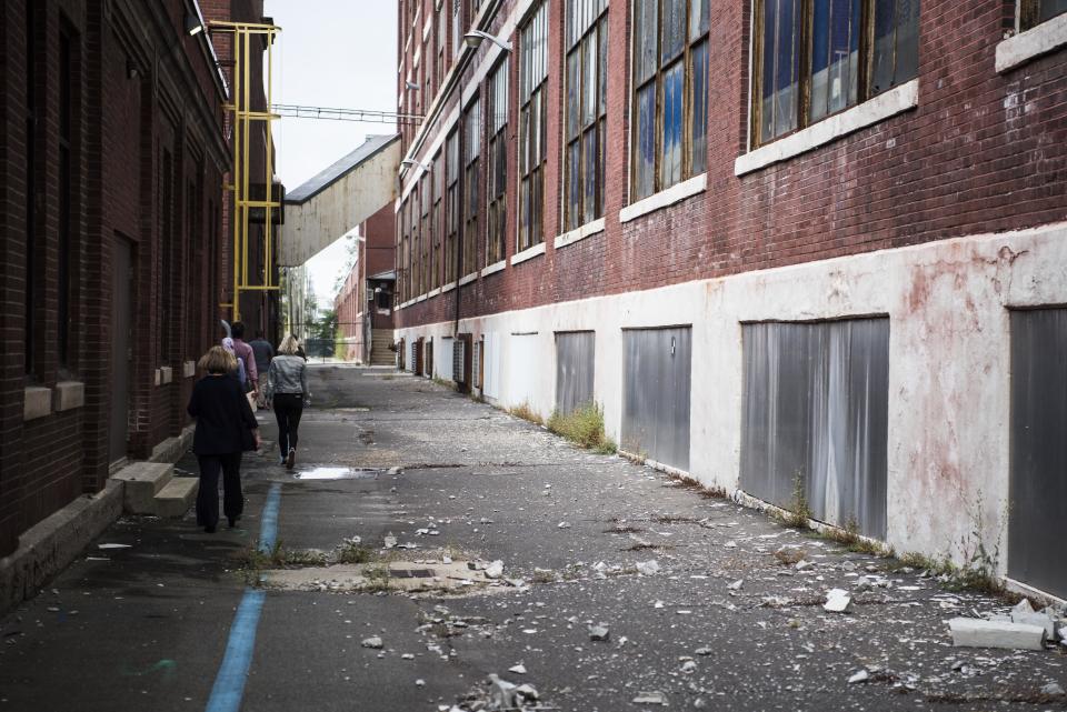 Walkways between buildings a littered with plaster that has fallen.