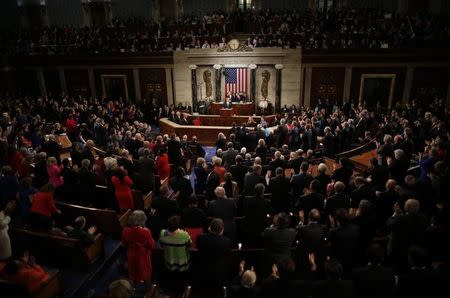 U.S. President Barack Obama gets a standing ovation from both sides of the aisle at the conclusion of his final State of the Union address to a joint session of Congress in Washington, January 12, 2016. REUTERS/Carlos Barria