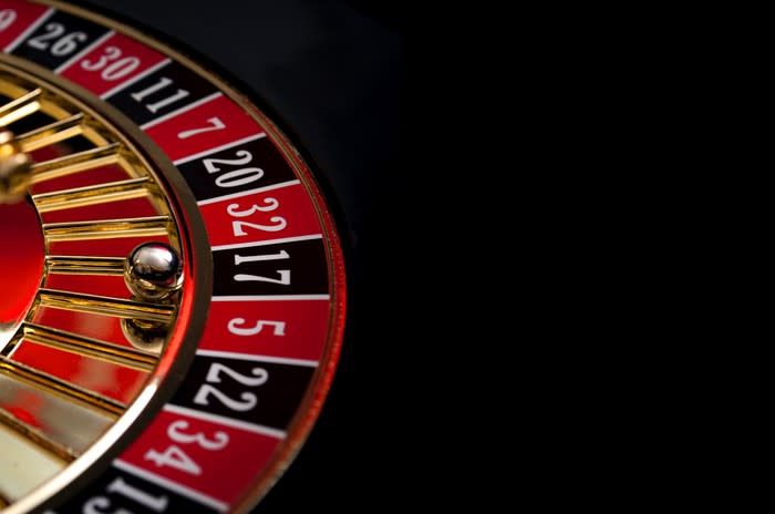 A roulette wheel on a black background