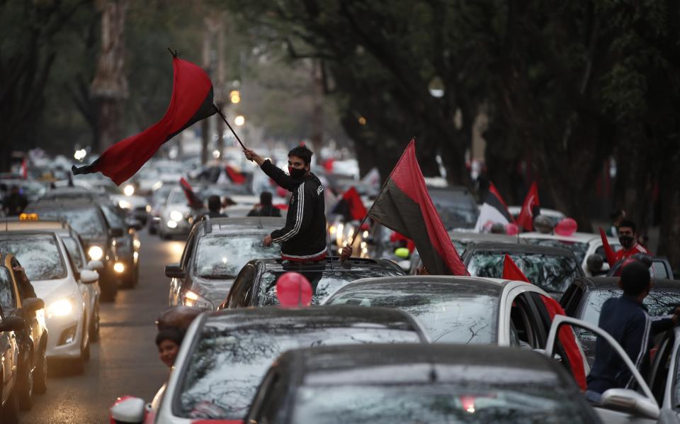 Fans of the Newell's Old Boys soccer club take part in a caravan in the hometown of soccer star Leonel Messi, in Rosario, Argentina, Thursday, Aug. 27, 2020. Fans hope to lure him home following his announcement that he wants to leave Barcelona F.C. after nearly two decades with the Spanish club. (AP Photo/Natacha Pisarenko)