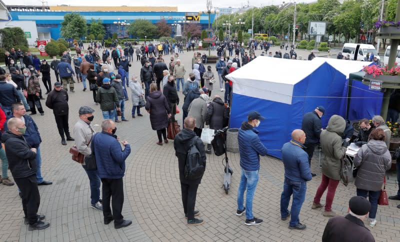 Opposition supporters wait in a line to put signatures in support of their potential candidates in the upcoming presidential election in Minsk