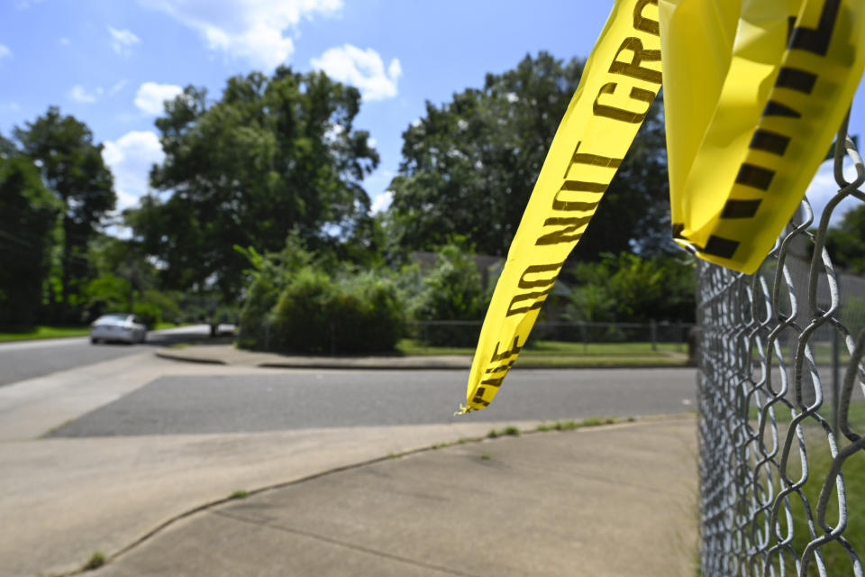 A remnant of crime scene tape hangs on a fence in the neighborhood of Whitehaven, where a gunman was arreseted, whom livestreamed himself driving around Memphis shooting at people, killing four and wounding three others in seemingly random attacks last night, shown Thursday, Sept. 8, 2022, in Memphis, Tenn. (AP Photo/John Amis)