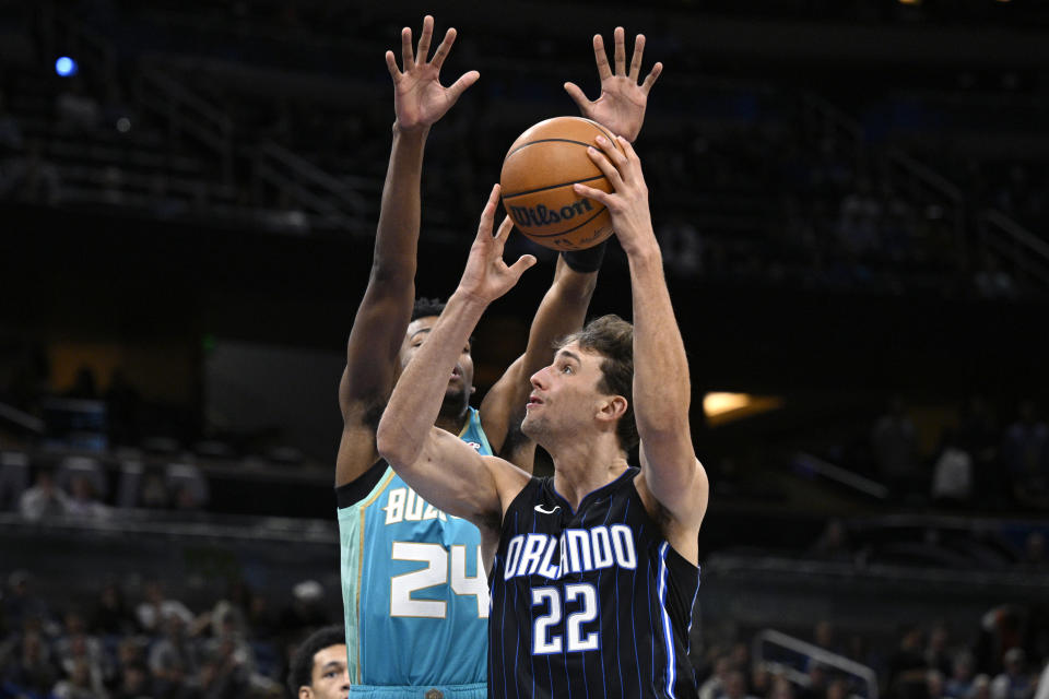 Orlando Magic forward Franz Wagner (22) goes up to shoot as Charlotte Hornets forward Brandon Miller (24) defends during the first half of an NBA basketball game, Tuesday, March 19, 2024, in Orlando, Fla. (AP Photo/Phelan M. Ebenhack)