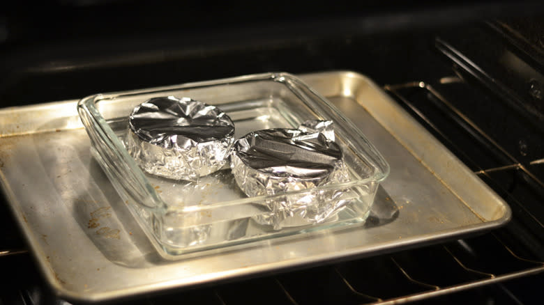 Creme caramels baking in a bain-marie in the oven