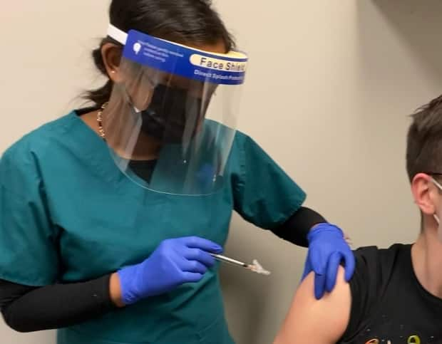 A volunteer receives an injection in this undated handout image provided by Providence Therapeutics. (Providence Therapeutics/The Canadian Press - image credit)