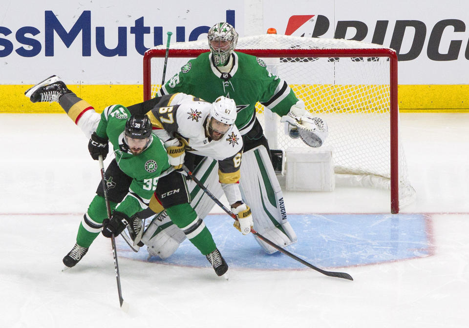 Dallas Stars' Joel Hanley (39) and Vegas Golden Knights' Max Pacioretty (67) battle in front of the net as Stars goalie Anton Khudobin (35) looks for the puck during second-period NHL Western Conference final playoff game action in Edmonton, Alberta, Saturday, Sept. 12, 2020. (Jason Franson/The Canadian Press via AP)