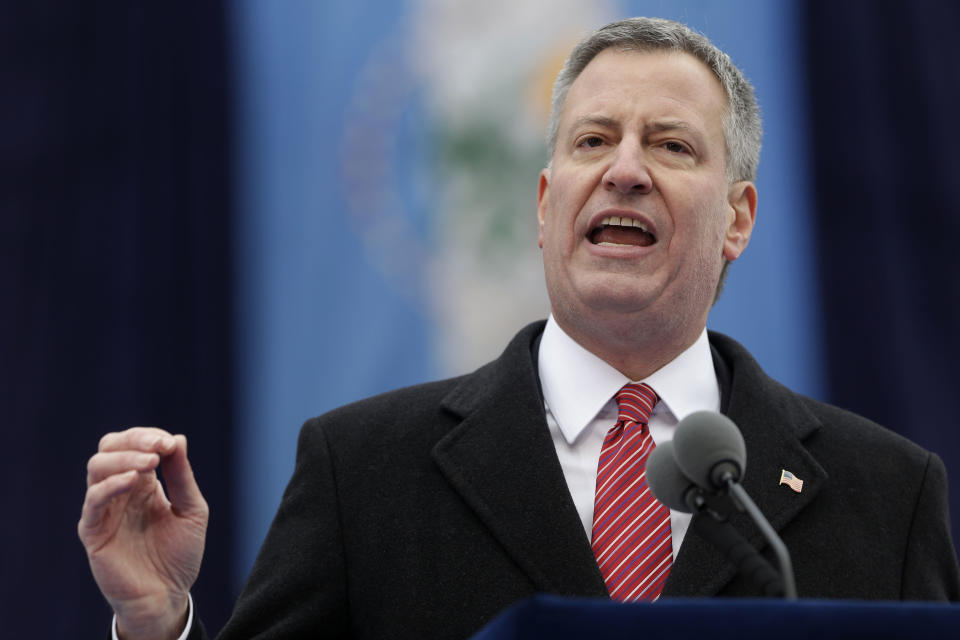 FILE - In this Jan. 1, 2014, file photo, New York City Mayor Bill de Blasio speaks after being sworn in during the public inauguration ceremony at City Hall in New York. Mayor de Blasio will not travel across the Hudson River to MetLife Stadium in East Rutherford, N.J., on Sunday for the Super Bowl that will be broadcast to a television audience expected to top 100 million people. De Blasio said Thursday, Jan. 30, that he has "decided to watch the game on TV, just like the vast majority of New Yorkers." (AP Photo/Seth Wenig, File)