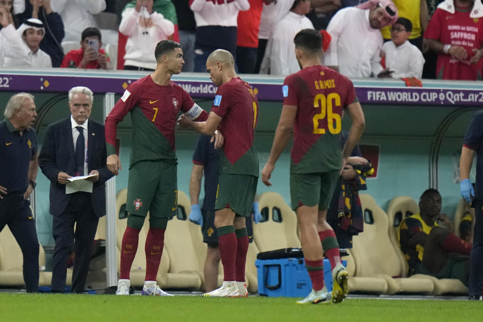 Portugal's Cristiano Ronaldo, left, prepares to enter as Portugal's Goncalo Ramos, right, walks during the World Cup round of 16 soccer match between Portugal and Switzerland, at the Lusail Stadium in Lusail, Qatar, Tuesday, Dec. 6, 2022. (AP Photo/Alessandra Tarantino)