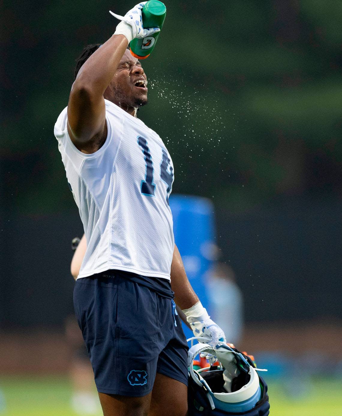 North Carolina’s Jaybron Harvey (14) cools off during the Tar Heels’ first practice of the season on Monday, July 29, 2024 in Chapel Hill, N.C.