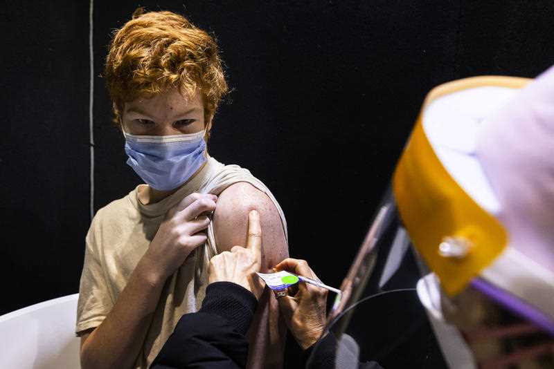 15 year old Jack Guganovic receives a vaccination at the pop-up vaccination clinic at Casey Fields in Melbourne.