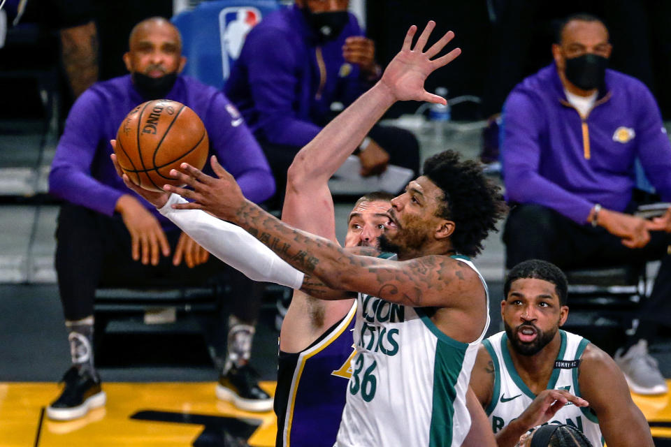 Boston Celtics' Marcus Smart (36) goes to the basket under pressure from Los Angeles Lakers' Marc Gasol (14) during the first half of an NBA basketball game Thursday, April 15, 2021, in Los Angeles. (AP Photo/Ringo H.W. Chiu)