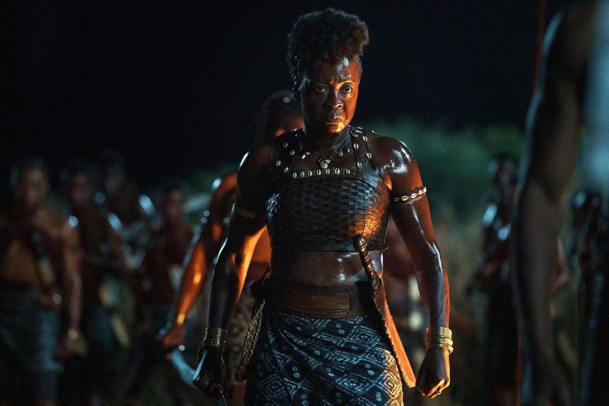 Viola Davis standing with a sword by her side