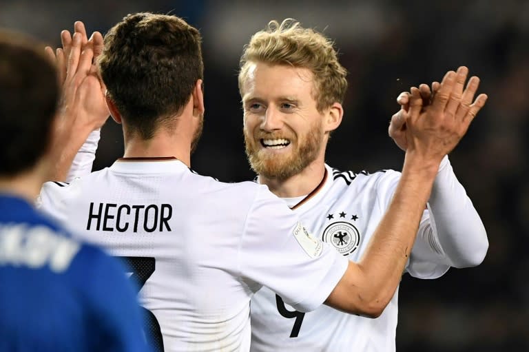 Germany's Andre Schuerrle (R) celebrates with Jonas Hector after scoring a goal against Azerbaijan on March 26, 2017