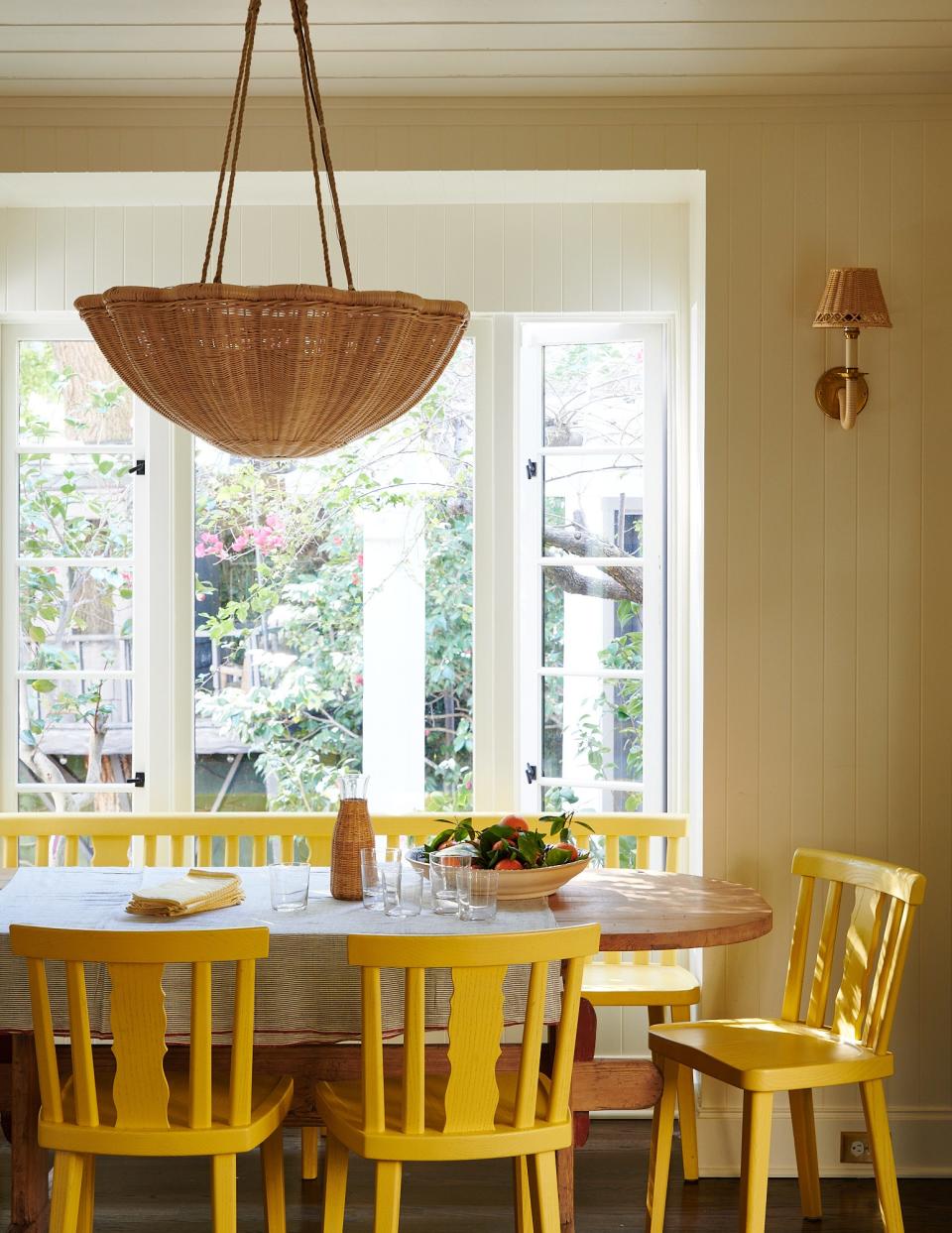 “It ended up being this beautiful space that we sit in every single second,” Wilson says of the breakfast nook that interior architect Doug Levine created. Nickey created bespoke yellow chairs and a matching bench and paired them with a vintage kitchen table from his shop, Nickey Kehoe. The pendant and sconces are from Soane Britain.