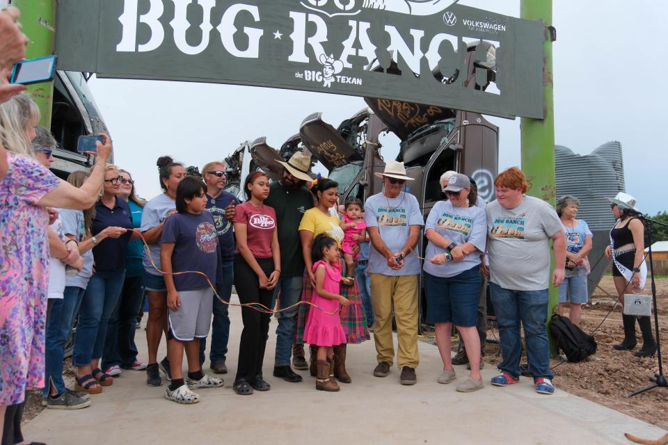 Bobby Lee of the Big Texan cuts the wire Friday at the christening of the new Big Texan Route 66 Bug Ranch in Amarillo.