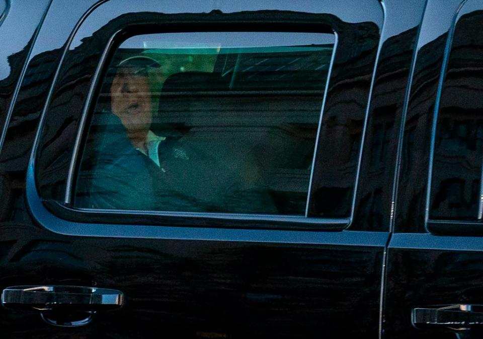 US President Donald Trump watches from the motorcade as he returns to the White House. Source: Getty