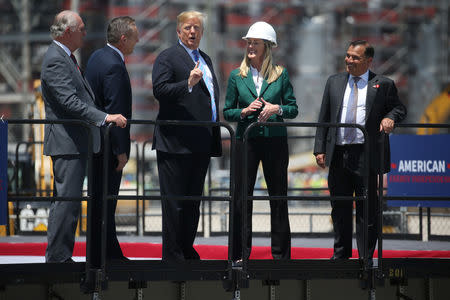 U.S. President Donald Trump speaks with Sempra Energy Lead Independent Director Bill Rusnack, Sempra Chairman and Chief Executive Officer Jeff Martin and Sempra Chief Operating Officer Lisa Glatch during a visit to the Cameron LNG (Liquid Natural Gas) Export Facility in Hackberry, Louisiana, U.S., May 14, 2019. REUTERS/Leah Millis