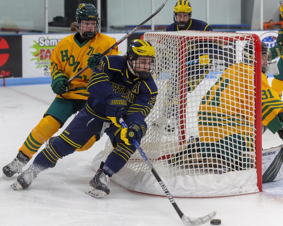 Howell's Cade Katlin (71) chases Hartland's Lucas Henry (21) behind the net during the Highlanders' 5-0 loss Wednesday, Jan. 11, 2023 at 140 Ice Den.