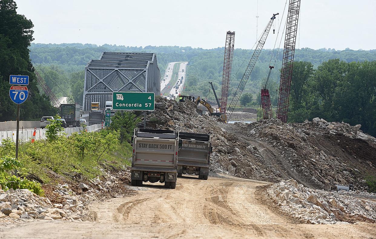 Construction workers haul limestone quarried from the river bluff to build roads to the construction area below the Rocheport Bridge on May 19. The first new bridge is expected to be completed in 2023 and the second bridge in 2024.
