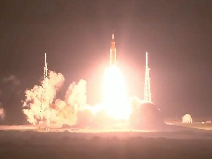 space launch system rocket lifts off from launchpad at night