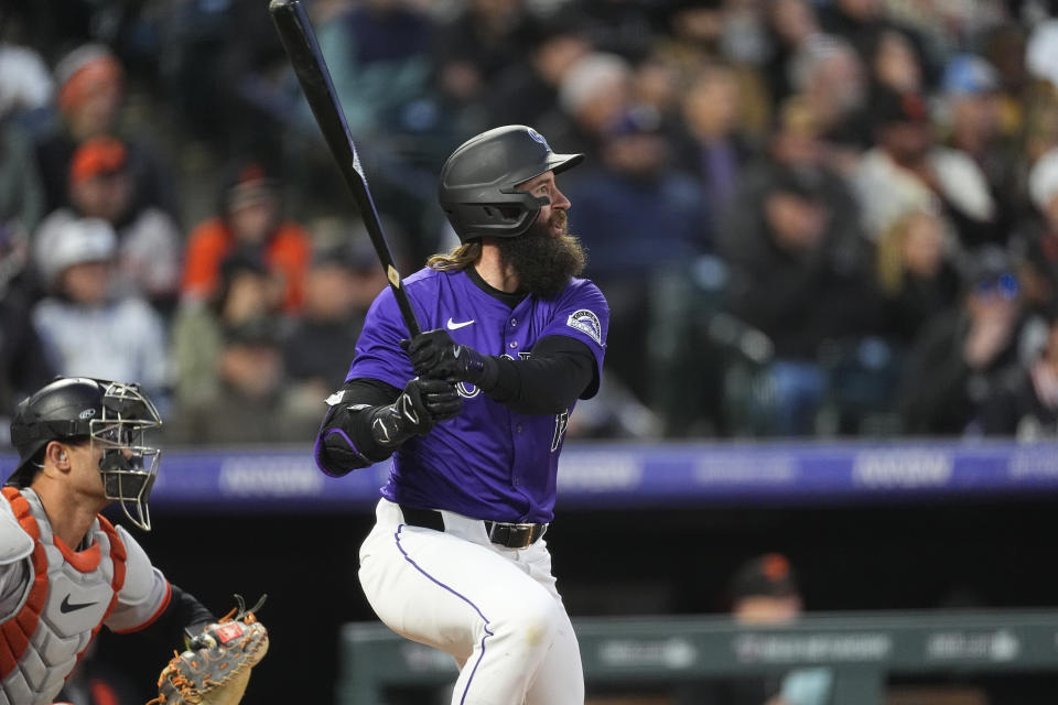 Colorado Rockies' Charlie Blackmon follows the flight of his RBI single off San Francisco Giants starting pitcher Jordan Hicks in the fifth inning of a baseball game Wednesday, May 8, 2024, in Denver. (AP Photo/David Zalubowski)