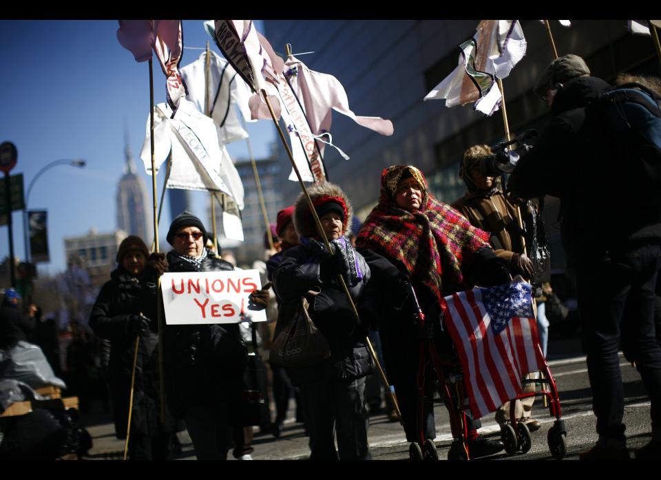 NEW YORK - MARCH 25:  Family members and attendees march along Broadway prior to a ceremony at the site of theTriangle Shirtwaist Factory fire March 25, 2011 in New York City. The ceremony marked the 100 year anniversary of the fire which killed 146 immigrant workers, most of them young women. Workers were locked into the factory during their shifts, preventing escape. New Yorkers watched in horror from below as workers leapt to their deaths from the windows above. Public outcry over the tragedy led to nationwide debate on workers rights and safety regulations and helped pave the way for strong workers unions. (Photo by Eric Thayer/Getty Images)