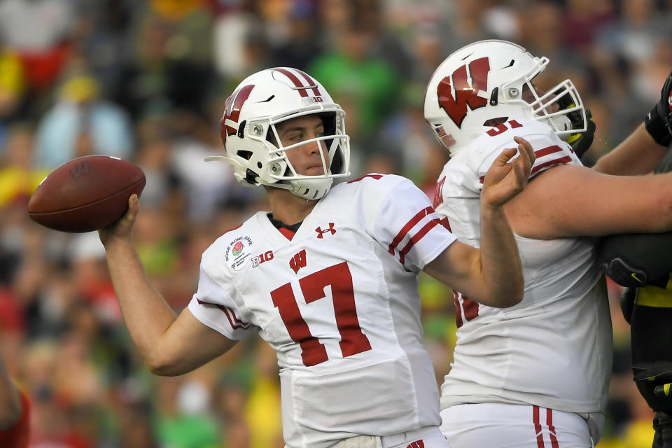 FILE - In this Jan. 1, 2020, file photo, Wisconsin quarterback Jack Coan passes against Oregon during first half of the Rose Bowl NCAA college football game in Pasadena, Calif. Coan is dealing with a foot injury as the Badgers prepare for the start of this pandemic-delayed season. Athletic department spokesman Brian Mason confirmed that Coan injured his foot in practice Saturday, Oct. 3, 2020, and did not practice Sunday. (AP Photo/Mark J. Terrill, File)