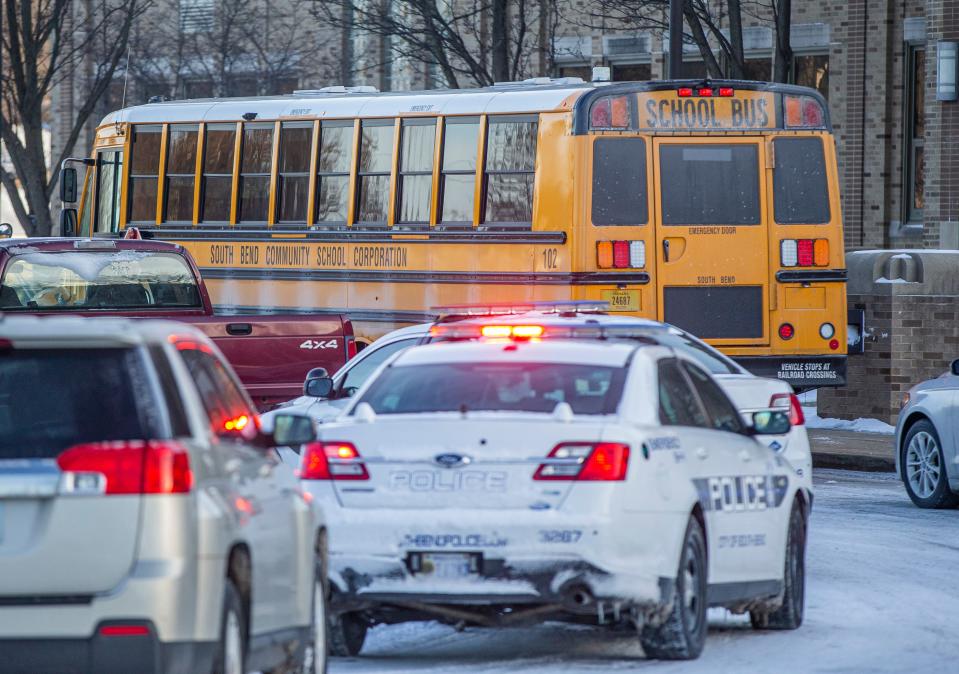 Police cars sit outside John Adams High School as the school continues a lockdown following an incident on Tuesday, Jan. 11, 2021, in South Bend.