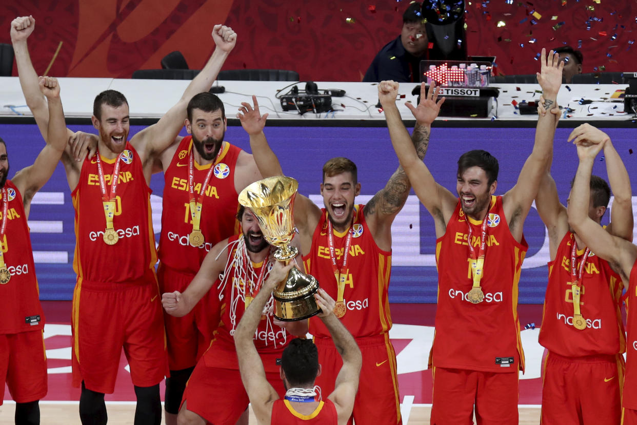 Spain's Marc Gasol, third from left cheer with teammates during the award ceremony for the FIBA Basketball World Cup Final, at the Cadillac Arena in Beijing, Sunday, Sept. 15, 2019. Spain has captured its second World Cup championship, defeating Argentina 95-75 on Sunday to give Marc Gasol a rare double-title year. (AP Photo/Ng Han Guan)