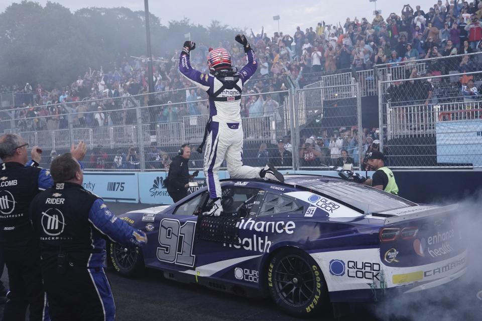 FILE - Shane Van Gisbergen celebrates after winning a NASCAR Cup Series auto race at the Grant Park 220 Sunday, July 2, 2023, in Chicago. Van Gisbergen took NASCAR by storm last season by winning the inaugural Chicago Street Race in his first-ever NASCAR Cup Series race.(AP Photo/Morry Gash, File)