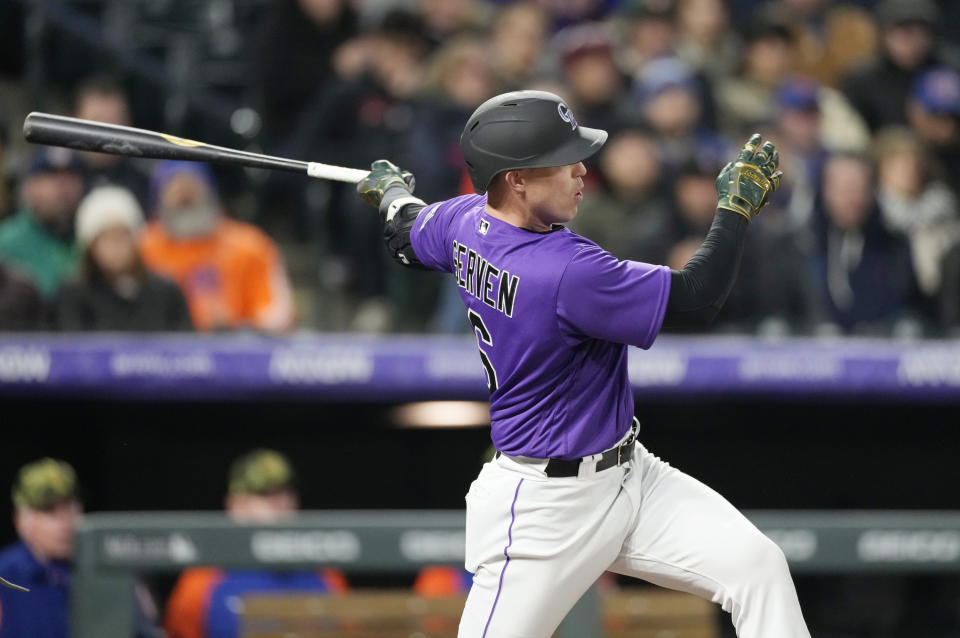 Colorado Rockies' Brian Serven follows the flight of his two-run home run off New York Mets relief pitcher Adonis Medina in the sixth inning of the second baseball game of a doubleheader Saturday, May 21 2022, in Denver. (AP Photo/David Zalubowski)
