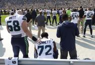 <p>Seattle Seahawks’ Michael Bennett remains seated on the bench during the national anthem before an NFL football game against the Green Bay Packers Sunday, Sept. 10, 2017, in Green Bay, Wis. (AP Photo/Jeffrey Phelps) </p>