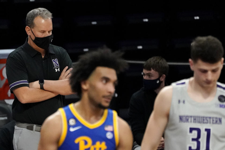 Northwestern head coach Chris Collins, left, reacts as he watches his team during the second half of an NCAA college basketball game against Pittsburgh in Evanston, Ill., Wednesday, Dec. 9, 2020. Pittsburgh won 71-70. (AP Photo/Nam Y. Huh)