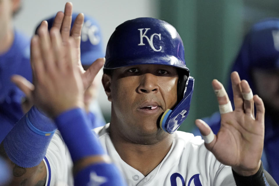 Kansas City Royals' Salvador Perez celebrates in the dugout after scoring on a single by Edward Olivares during the third inning of a baseball game against the Minnesota Twins Wednesday, Sept. 21, 2022, in Kansas City, Mo. (AP Photo/Charlie Riedel)
