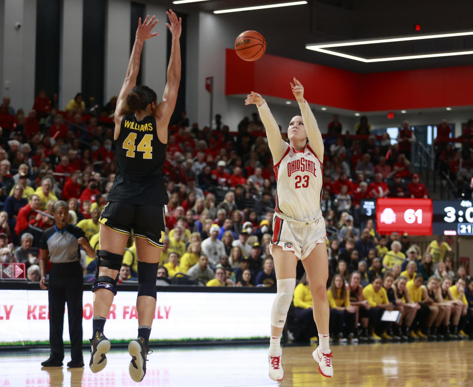 Ohio State forward Rebeka Mikulášiková, right, shoots in front of Michigan forward Cameron Williams during the second half of an NCAA college basketball game in Columbus, Ohio, Saturday, Dec. 31, 2022. Ohio State won 66-57. (AP Photo/Paul Vernon)