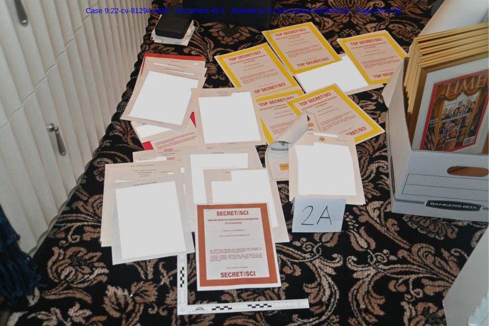 FILE - This image contained in a court filing by the Department of Justice on Aug. 30, 2022, and redacted by in part by the FBI, shows a photo of documents seized during the Aug. 8 search by the FBI of former President Donald Trump's Mar-a-Lago estate in Florida. The discovery of classified documents at the home of former Vice President Mike Pence is scrambling the blame game in Washington. Now, lawmakers from both parties seem united in frustration with the string of mishaps in the handling of the U.S. government's secrets.(Department of Justice via AP, File)