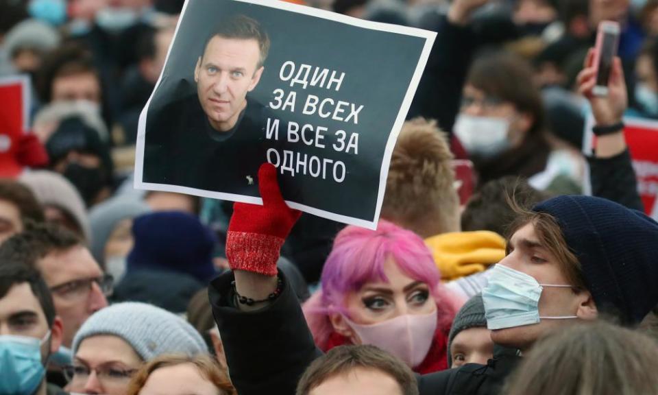 A man holds a portrait of Alexei Navalny at a rally in Moscow.