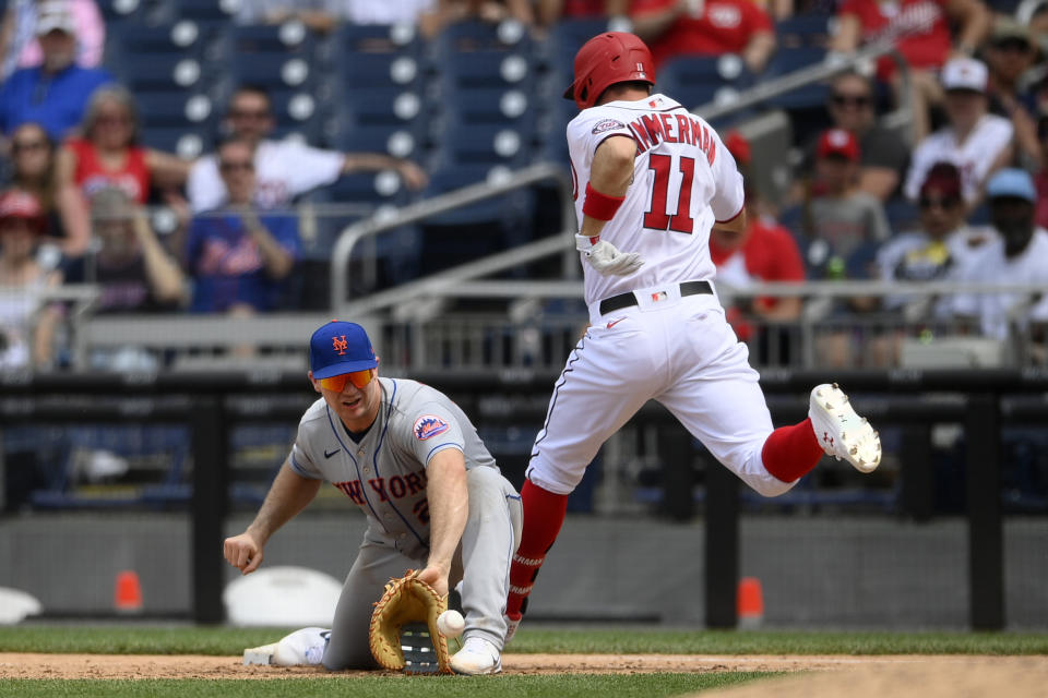 Washington Nationals' Ryan Zimmerman (11) is out at first as New York Mets first baseman Pete Alonso (20) fields the throw during the sixth inning of the first baseball game of a doubleheader, Saturday, June 19, 2021, in Washington. The Mets won 5-1. (AP Photo/Nick Wass)