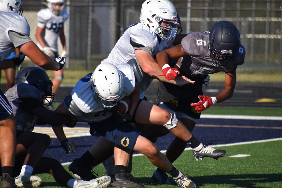 Decatur Central's Russell Peterson lays the boom on a Castle ball carrier during the Hawks' four-way scrimmage with the Knights, Bloomington North and Speedway on June 23, 2022.